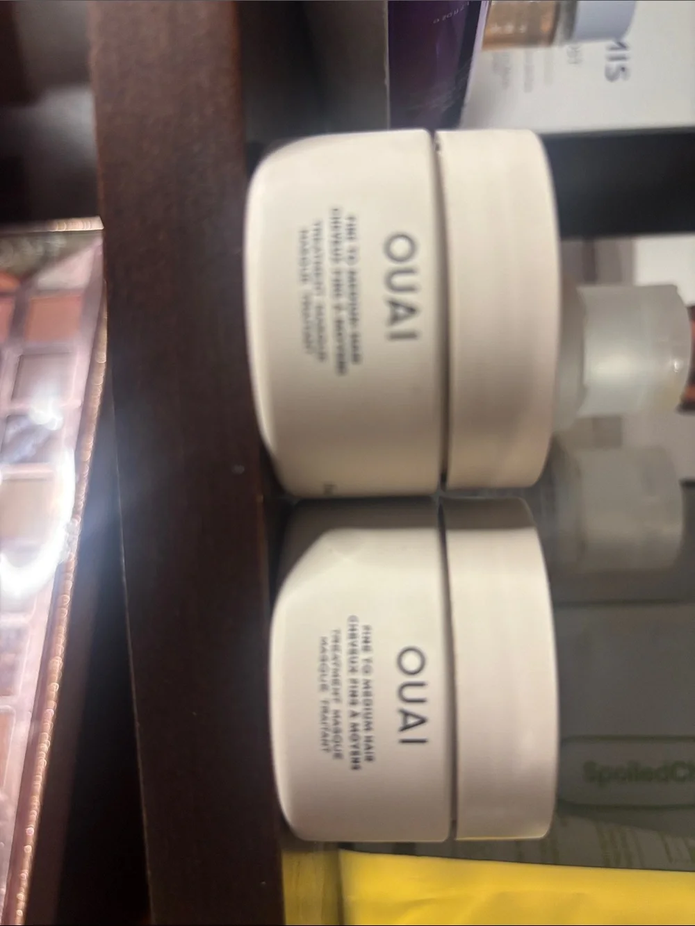 OUAI cream moisturizer jars in off-white